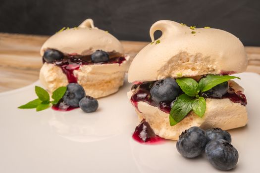 French meringue cookies with blueberry jam