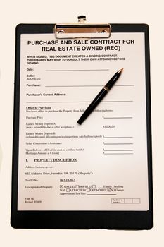 The form of the contract with a black pen on a white background