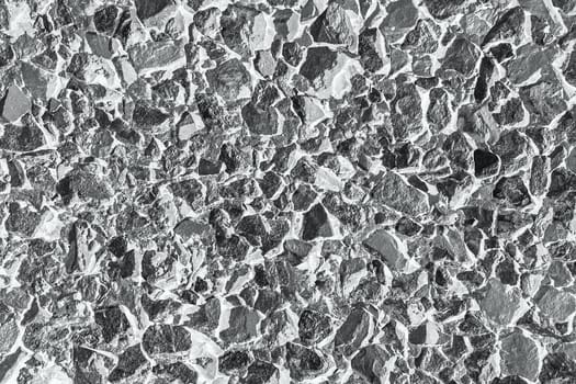 Background of chipped stones wall texture photo. Black and white photography