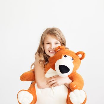 Little girl with big teddy bear having fun laughing Isolated on white background