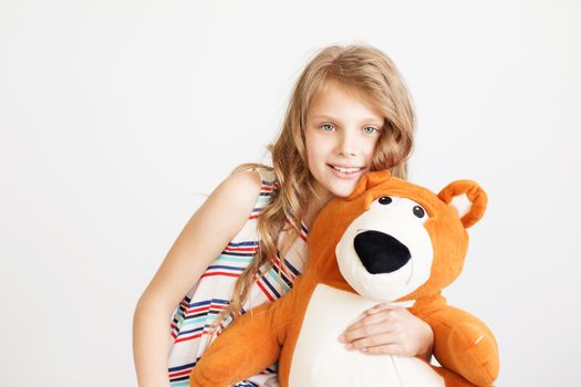 Little girl with big teddy bear having fun laughing Isolated on white background