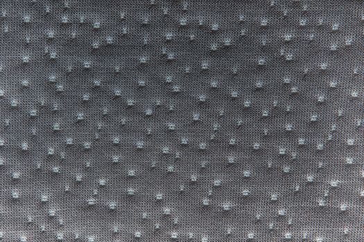 Gray fabric dotted texture. Clothes background. Close up