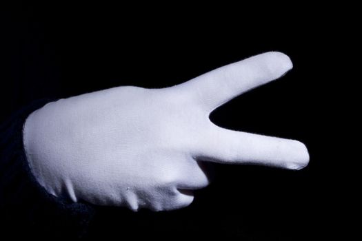 Hand in glove with white cloth gesturing