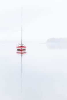 Single boat in a misty day