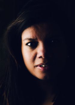 Dark and moody portrait of asian woman