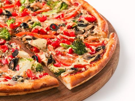 Close up view on a piece of vegetarian pizza with cauliflower, pepper, olives, onions on wooden cutting board. Isolated on white with clipping path