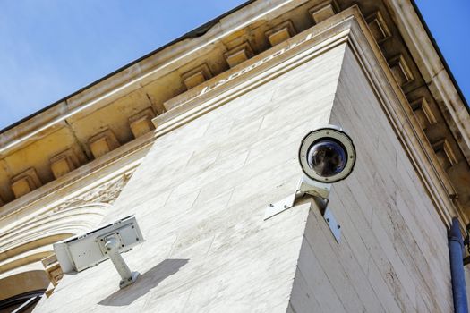 security CCTV camera or surveillance system fixed on old construction wall