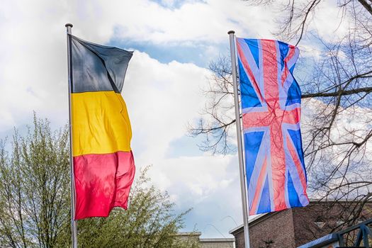 Country flags arranged against a blue sky.
