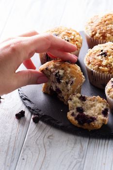 Closeup female hands  and cup cake with fresh berries. Blueberry muffins with fresh berries. homemade blackberry muffins 