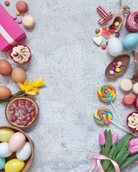 Assorted easter sweets, bakery cupcakes, chocolate eggs and confectionery with background space