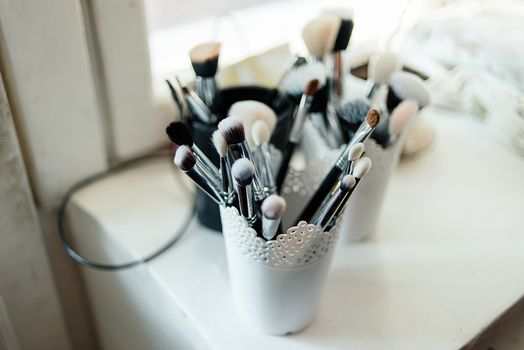 Brushes for make-up stand in the white cup