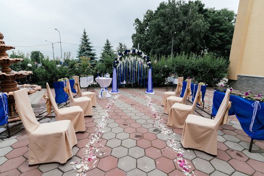 Place for a wedding ceremony with an arch and chairs