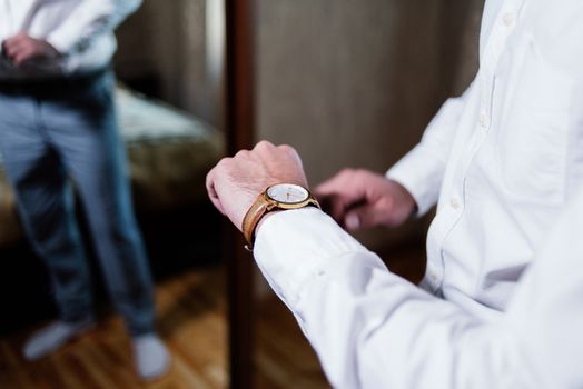 Watch on the wrist of a man in a white shirt