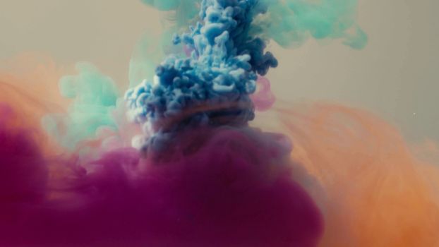 Close up of four colors of ink dropped into the water