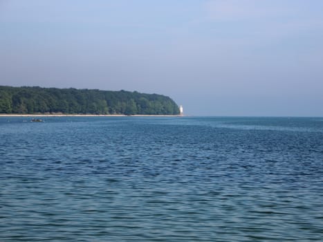 Long Natural Coastline with Forest Beach and Light Tower