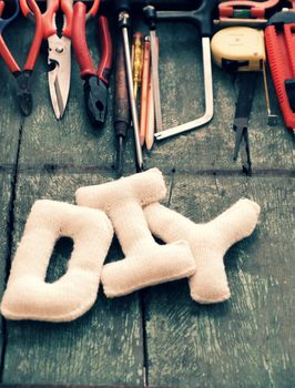 Diy tools background with group of crafting tools like scissors, hammer, knife, equipment for handmade product on wood background, a hobby of dad to repair in home