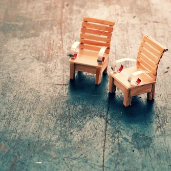 Amazing miniature handmade product for interior design, mini furniture make from wood stick on wooden background, small chair so cute, a hobby leisure