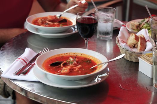Bowl of spicy fish soup with tomatoes and mussels