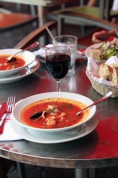 Bowl of spicy fish soup with tomatoes and mussels