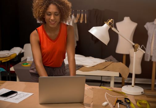 A young fashion designer working on her atelier