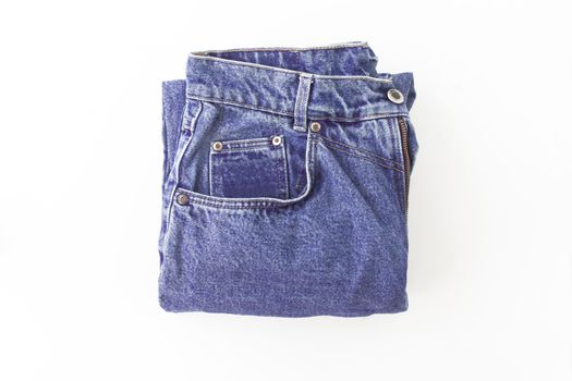 Purple, violet retro jeans neatly folded, isolated.