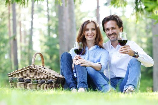 Young beautiful couple on picnic in summer park