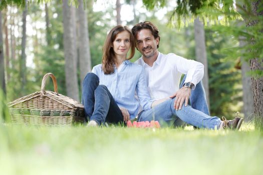 Young beautiful couple on picnic in summer park