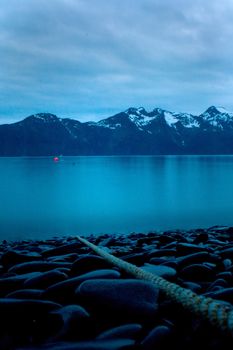 Smooth stones on the Alaskan coastline near Seward at night. 
