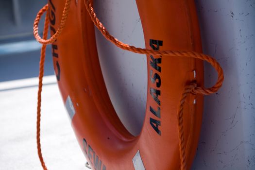 A ring-shaped orange floatation device on a tour boat in Seward, Alaska. 