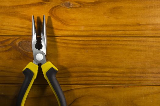 Close up of a multitool pliers on wooden background