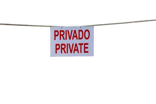 Old sign reading in Spanish private.