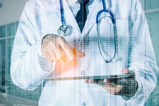 Male doctor holds laptop working with communication technology.