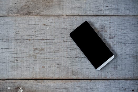 Cell phone on the old wooden floor.