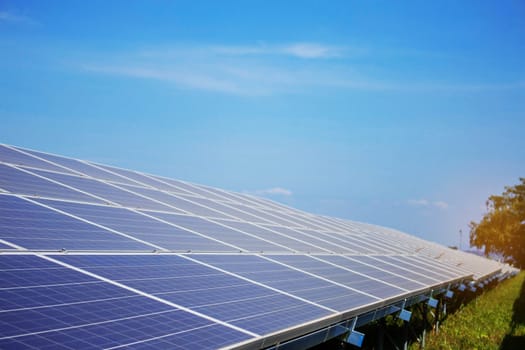 Solar panel on grassland with blue sky.