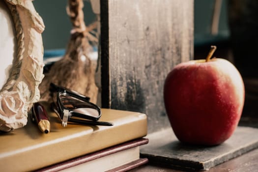 Old stationery and apple on the desk.