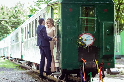 Just married happy couple on the ladder last wagon in Lviv, Ukraine