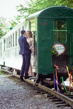 Just married happy couple on the ladder last wagon in Lviv, Ukraine