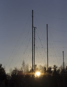 Silhouette Antenna against the sky at sunrise.