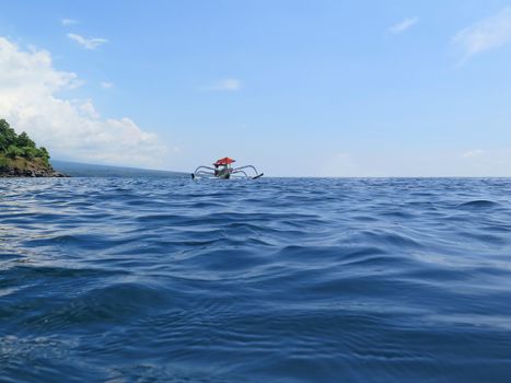 Traditional fishing boats floating on the sea Bali, Indonesia.