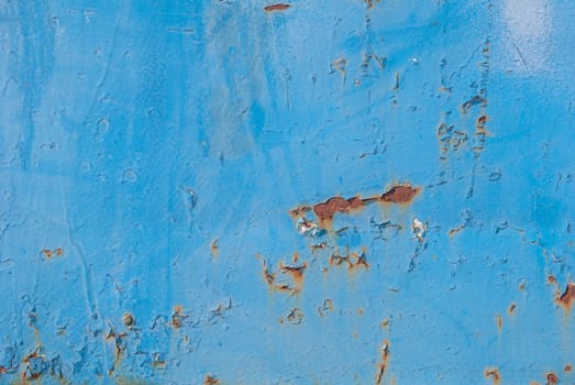 fragment of an iron surface is covered with blue color paint, which has long been under the influence of different climatic conditions