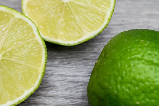 Slices of lime in a wooden bacground