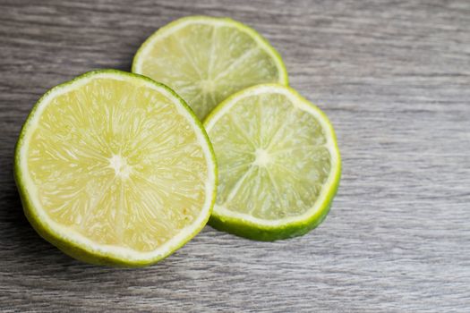 Slices of lime in a wooden bacground