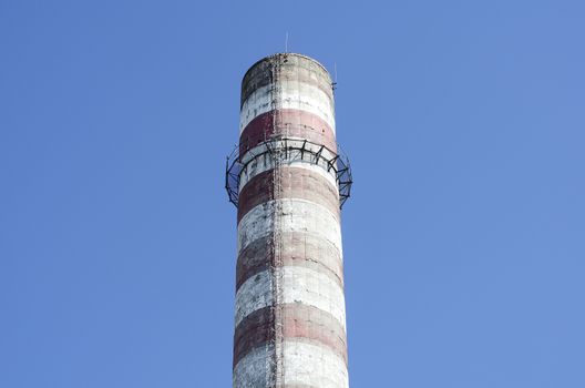 Industrial chimney against blue sky