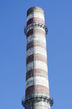 Industrial chimney against blue sky