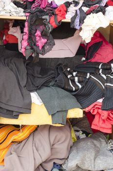 Pile of carelessly scattered clothes in wardrobe