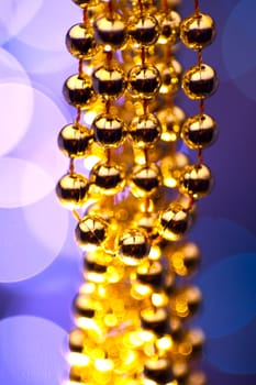 Golden Christmas Ornaments - Bokeh Lights in the Background. Violet-Blue Background.