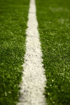 Football Field Line. White Field (Sport) Line on the Green Grassy Field. Vertical DOF Photo.