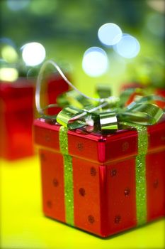 Christmas Gift Box. Red Boxes with Green Bows. Green Bokeh. Cool Christmas Theme.