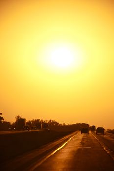 Sunset on the Road - Vertical Photo. Sunset in Front od Driver. American Midwest Highway.