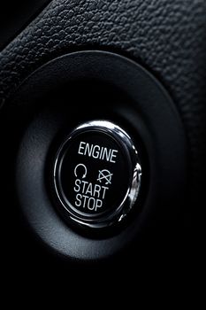 Black Engine Start Button in Modern Vehicle. Close Shot. Chrome Elements. Vehicles Interior Design Photo Collection.